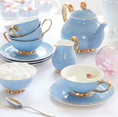 a table topped with blue dishes and cups