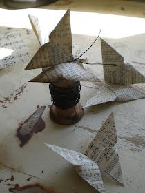 several pieces of paper are placed on top of a table covered in music sheet shapes