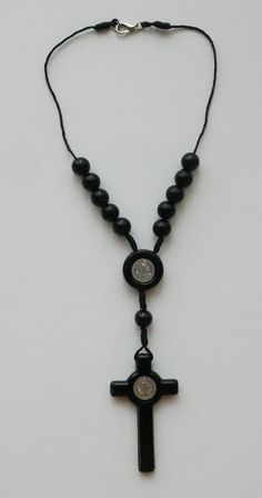 "Precision molded black plastic beads assembled on a black cord with clasp. SIZE/LENGTH: Total length is 9-1/2\" including the silver tone crucifix. CRUCIFIX: 2-1/2\" X 1-3/8\" CENTER PIECE: 13/16\" diameter BEADS: Quality 3/8\" plastic beads (9 mm) carefully assembled on a black cord. A Timeless Gift ~ Perfect for any person with a car or truck! This is a very good quality and elegant car rosary for use as a rearview interior mirror decoration for your car. Come Visit Us at Our New Store! Pleas Car Rosary, Interior Mirror, Mirror Decoration, Saint Benedict, Mirror Interior, Timeless Gifts, Plastic Beads, Black Plastic, Black Beads