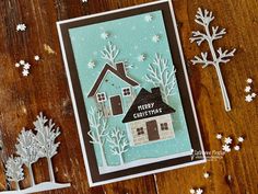 a christmas card made with stampin's house and snowflakes on a wooden table