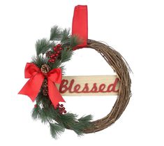 a christmas wreath with a red bow and the word blessing hanging on it's side