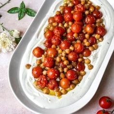 tomatoes and chickpeas on a white platter