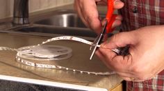 a person cutting up some tape on top of a counter