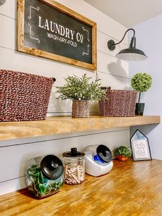 a wooden shelf topped with baskets filled with plants