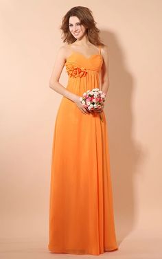 a woman in an orange dress holding a bouquet