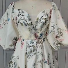 a white dress with floral print on it