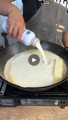 a person is cooking food in a pan on top of the stove with a white spatula