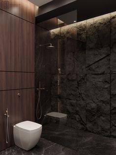 a modern bathroom with black marble walls and flooring, along with a walk in shower