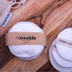 three reusable pads sitting on top of a wooden table