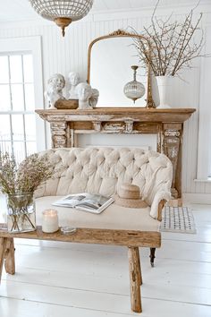 a living room with a couch, table and vases on top of the coffee table