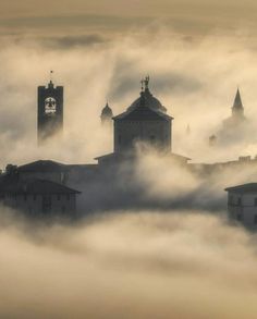 fog covers the city skyline as it rises above the clouds