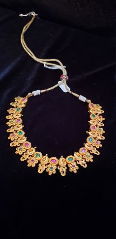 "Handmade Indian Temple Jewelry, best to wear it for traditional ceremonies or Indian wedding. This bridal jewelry has ethnic finish. It has Cubic Zircon stones with ruby and emeralds. It is a Bollywood style one gram jewelry. There are long and short patterns of Indian jewelry in Kundan, Pearls, CZ, American Diamond , ruby, emerald, Polki, kemp to suit every occasion of South Indian and North Indian weddings. Handmade Indian Jewelry item * Stunning Hand made Traditional jewelry set. * Necklace 22k Gold Chandbali Bridal Necklace In Temple Jewelry Style, Wedding Temple Jewelry Pearl Necklace, 22k Gold Meenakari Bridal Necklace In Temple Jewelry Style, 22k Gold Kundan Necklace In Temple Style, 22k Gold Hand-set Kundan Necklace In Temple Style, Hand Set Chandbali Temple Necklace For Puja, 22k Gold Chandbali Bridal Necklace With Pallu, 22k Gold Jewelry With Zari Work For Puja, Yellow Gold Temple Jewelry With Zari Work