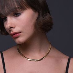 Introducing the stunning Foxy Necklace, the perfect accessory for anyone looking to add a touch of elegance and sophistication to their wardrobe. Made from high-quality 18k gold plated brass, this necklace is both luxurious and durable, ensuring it will last for years to come. With a length of 16 inches and a 1-inch extender, this necklace is adjustable to fit most neck sizes comfortably. Its sleek and shiny design is eye-catching yet subtle, making it the perfect accessory for any occasion, fro Elegant Herringbone Chain Choker Necklace, Elegant Snake Chain Clavicle Necklace, Elegant Clavicle Snake Chain Necklace, Classic Gold Necklace With Snake Chain, Elegant Snake Chain Necklace For Formal Occasions, Elegant Formal Necklace With Snake Chain, Elegant Formal Snake Chain Necklace, Elegant Gold-plated Herringbone Necklace, Elegant Plated Yellow Gold Chain Necklace