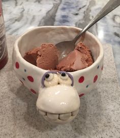 a bowl filled with ice cream next to a bottle