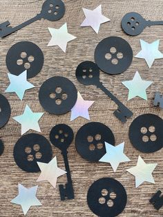 black and white paper cut out with stars on the table next to scissors, spoons and other items