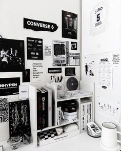 a white desk topped with lots of black and white items