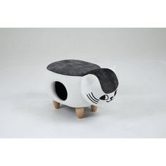 a white and black cat shaped stool with wooden legs