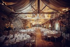 an indoor wedding venue set up with tables and chairs