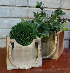 two planters with plants in them sitting on a table