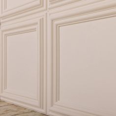 a bathroom with white walls and tile flooring next to a toilet in the corner