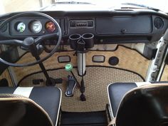 the interior of an old car with steering wheel and dash lights, dashboard controls and gauges