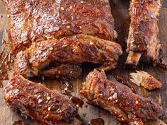 ribs covered in bbq sauce on a cutting board