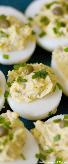 deviled eggs with chives and green onions on them