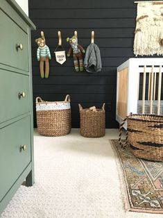 a baby's room with black walls and white carpet