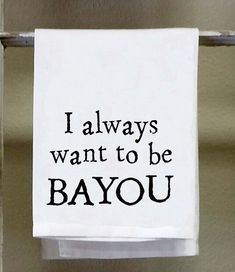 a white towel hanging on the side of a door saying i always want to be bayou