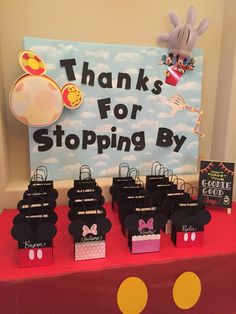 a table with mickey mouse bags on it and a sign that says thanks for stopping by