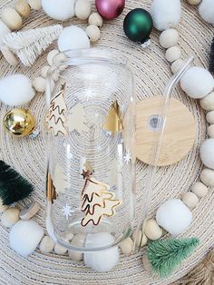 a glass jar sitting on top of a table next to christmas decorations and other items