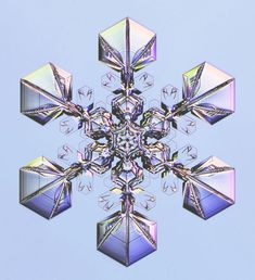 an abstract snowflake is shown against a blue sky