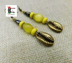 These are a long beaded antique bronze yellow beaded earring which is approximately 3 inches long. The beads are handmade and light weight.  If you have any questions please feel free to contact us at anytime. All shipping options are available. All items will be shipped out Monday through Friday. Receipts will be emailed out for immediate access. All items will be shipped out carefully and every shipment can be made with extra insurance upon request. All other concerns and details can be found in our policy section. Our goal is for your 100% satisfaction. If you would like to make a large order please contact us for a coupon code. Our products are not intended for babies or children as we use small pieces, wires and beads. These can be dangerous to them when unsupervised. Gift boxes and g Yellow Bohemian Metal Earrings, Adjustable Yellow Earrings With Large Beads, Adjustable Yellow Beaded Earrings With Large Beads, Adjustable Yellow Earrings With Gold Beads, Yellow Bohemian Beaded Earrings With Gold Beads, Bohemian Yellow Beaded Earrings With Gold Beads, Yellow Earrings With Gold Beads, Bohemian Yellow Brass Jewelry, Handmade Yellow Brass Earrings