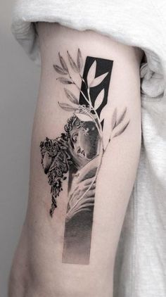 a black and white photo of a woman's leg with flowers on it,