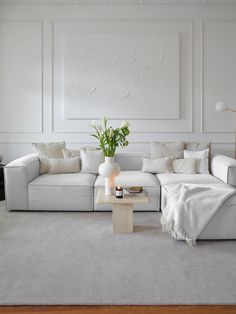 a living room with white walls and furniture