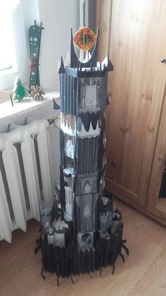 a castle made out of toilet paper on the floor next to a radiator