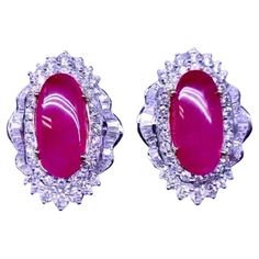 An exquisite pair of earrings with a exclusive design, so unique and elegant , by Italian designer, in 18k gold with 2 natural Burma rubies in oval cut of 15,00 carats, fine quality, and natural diamonds in round and baguettes cut of 4,90 carats, F/VS. It is a very piece of art , high jewelry. Handcrafted by artisan goldsmith. Excellent manufacture and quality. Complete with report. Wholesale price. Note: on my shipment, customers not pay taxes and duty. Exquisite Ruby Earrings In White Gold, Exquisite Cabochon Earrings For Formal Occasions, Exquisite White Gold Ruby Earrings, Diamond Cabochon Earrings For Anniversary, Formal Cabochon Earrings In Fine Jewelry Style, Formal Cabochon Fine Jewelry Earrings, Anniversary Diamond Cabochon Earrings, Exquisite Formal Cabochon Earrings, Luxury Oval Ruby Earrings