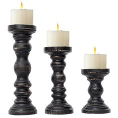 three black candlesticks with one lit and the other turned off in different directions