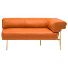 an orange leather couch sitting on top of a metal frame