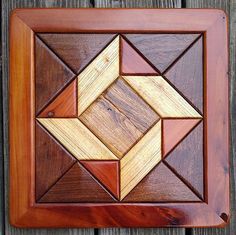 a wooden wall hanging with an abstract design on it