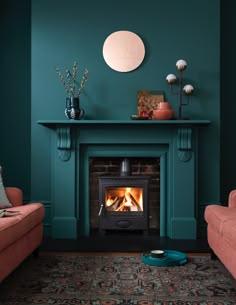 a living room with a fire place and two chairs