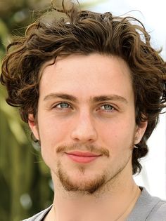 a close up of a person with curly hair