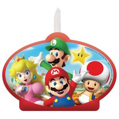 mario and friends cake topper on a red plate with white candles in front of it