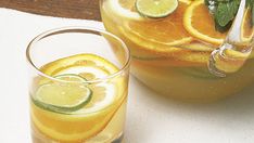 two glasses filled with lemonade and lime slices