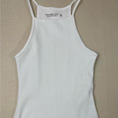 Bnwt Abercrombie & Fitch Bodysuit. Size Xs White Bodysuit Tank Top White Fitted Tank Bodysuit, Fitted White Tank Bodysuit, White Ribbed Fitted Bodysuit, White Fitted Ribbed Bodysuit, Fitted White Ribbed Bodysuit, White Stretch Racerback Bodysuit, White Racerback Bodysuit For Summer, Casual White Ribbed Bodysuit, Black Bodysuit Longsleeve