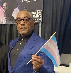 a man in a blue suit holding a flag