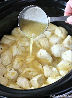 someone pouring sauce into an crock pot filled with food