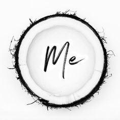 a coconut with the word me written on it in cursive black and white