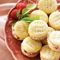 a red bowl filled with cookies and strawberries