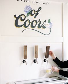 a woman pours a glass of wine into a toaster in front of a sign that says do you love me?